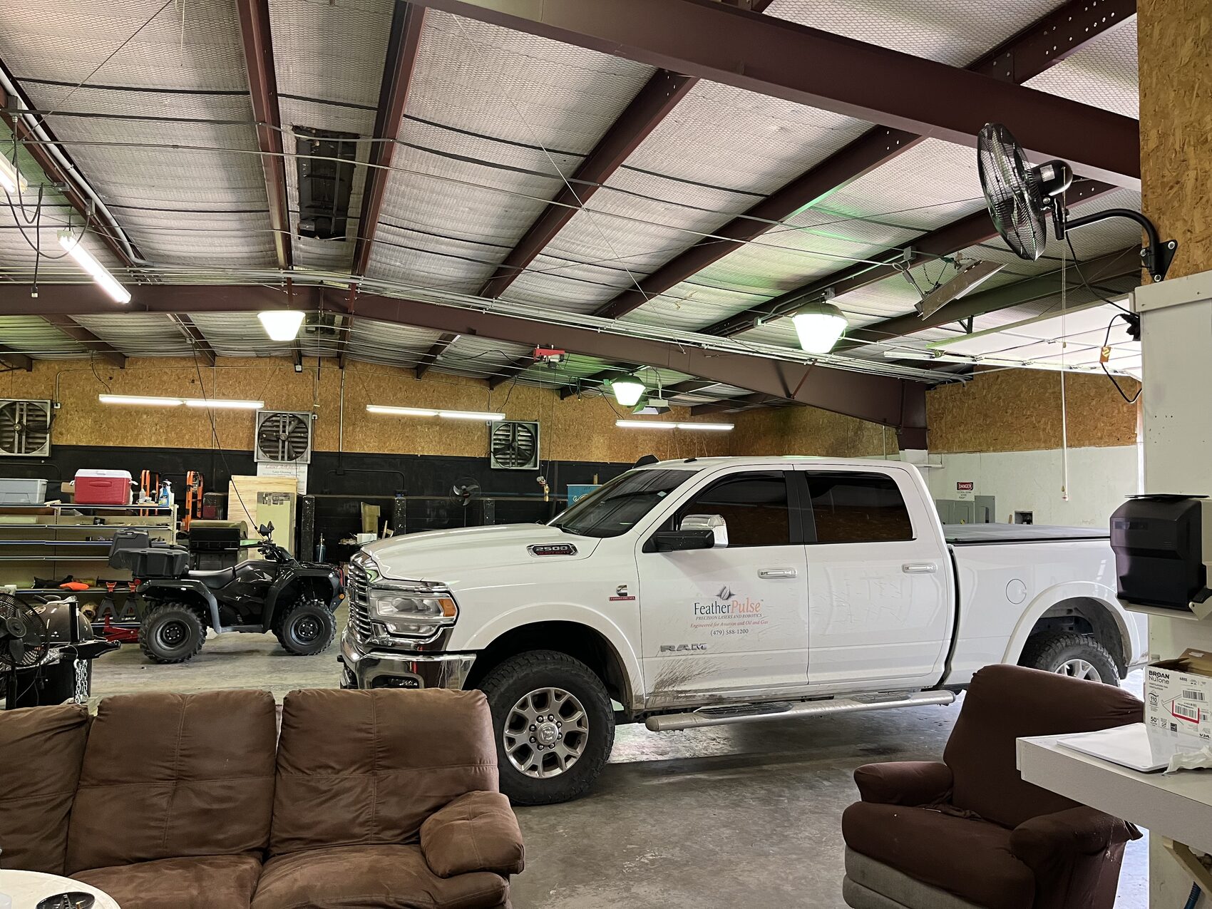 Drive-in shop bay with a pickup truck inside